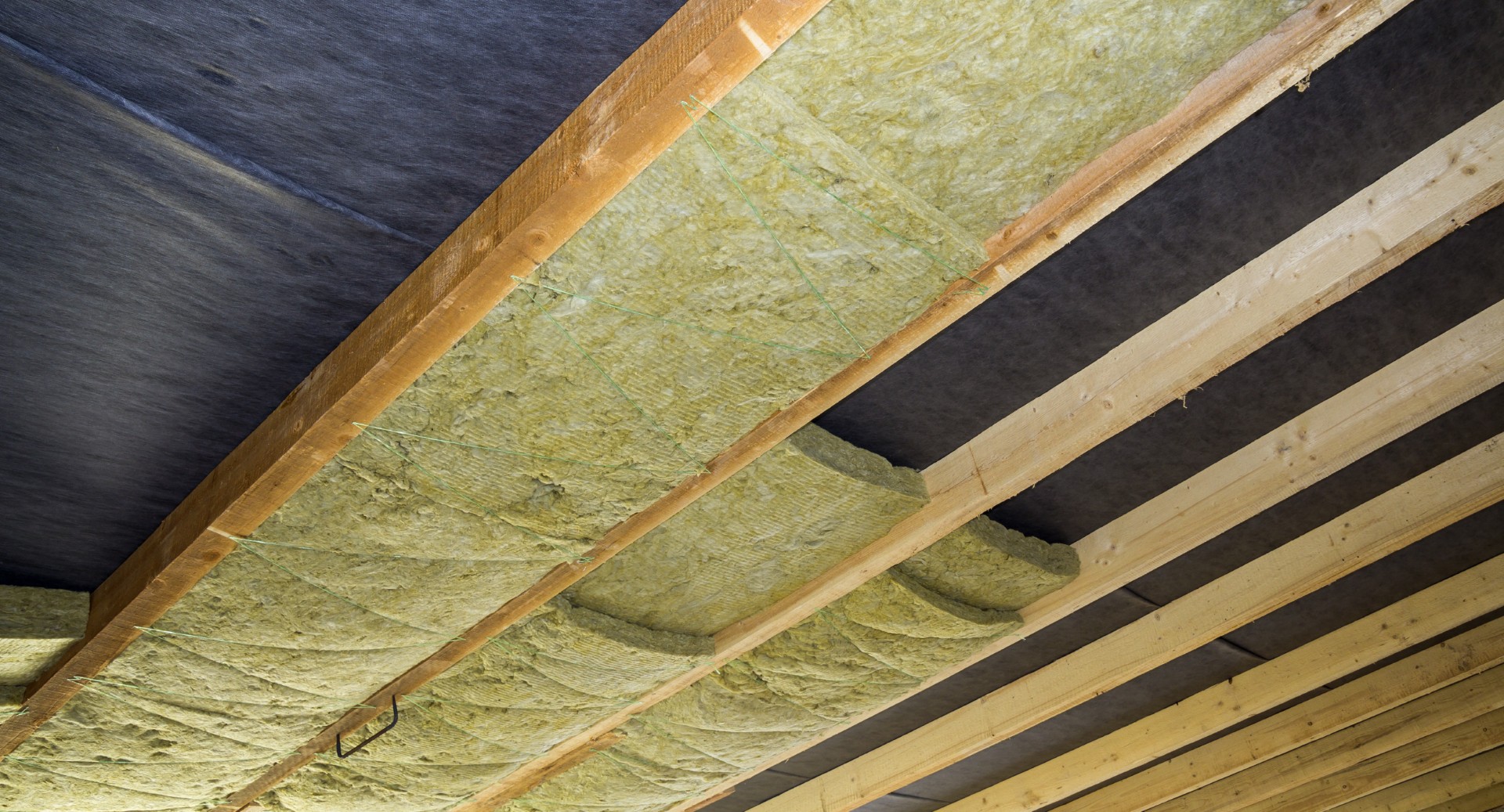 Thermal insulation mineral rock wool installation at the new building attic ceiling